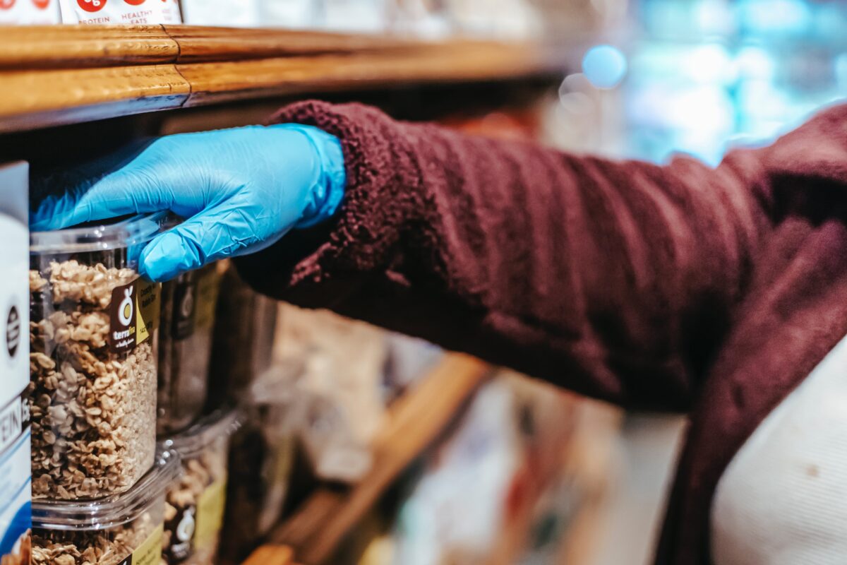 Women selecting food in plastic container