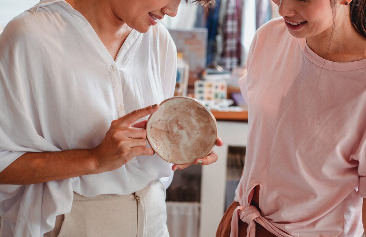 Women choosing ceramic plate