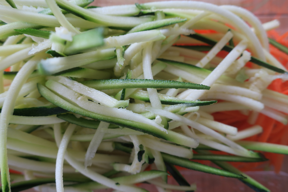 A colorful pile of zucchini and carrots, fresh and vibrant, ready to be used in a delicious meal.