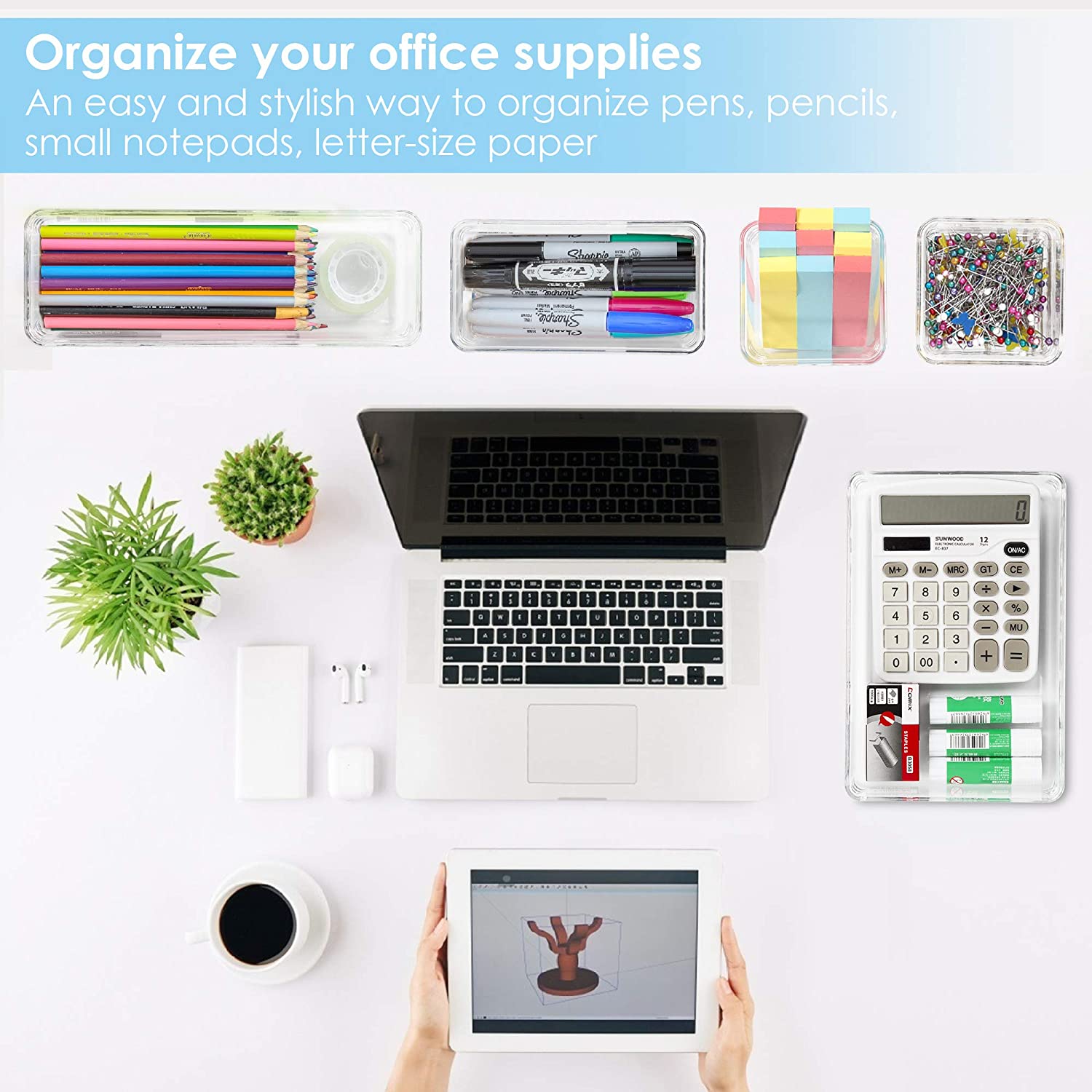 A person sitting at a desk using a laptop and a tablet to organize office supplies