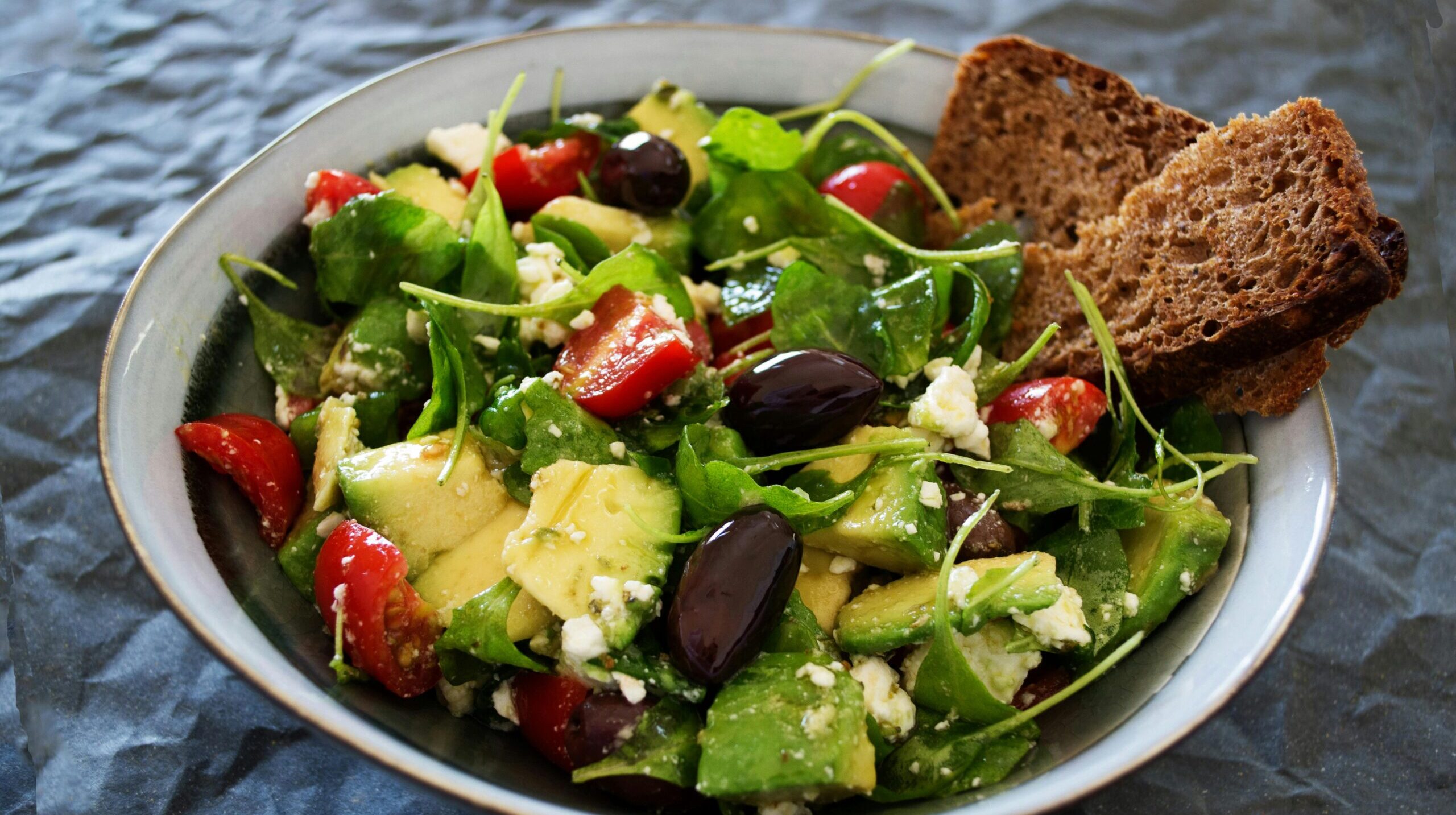 Avocado, tomato, and feta salad a vibrant mix of fresh ingredients, combining creamy avocado, juicy tomatoes, and tangy feta cheese.