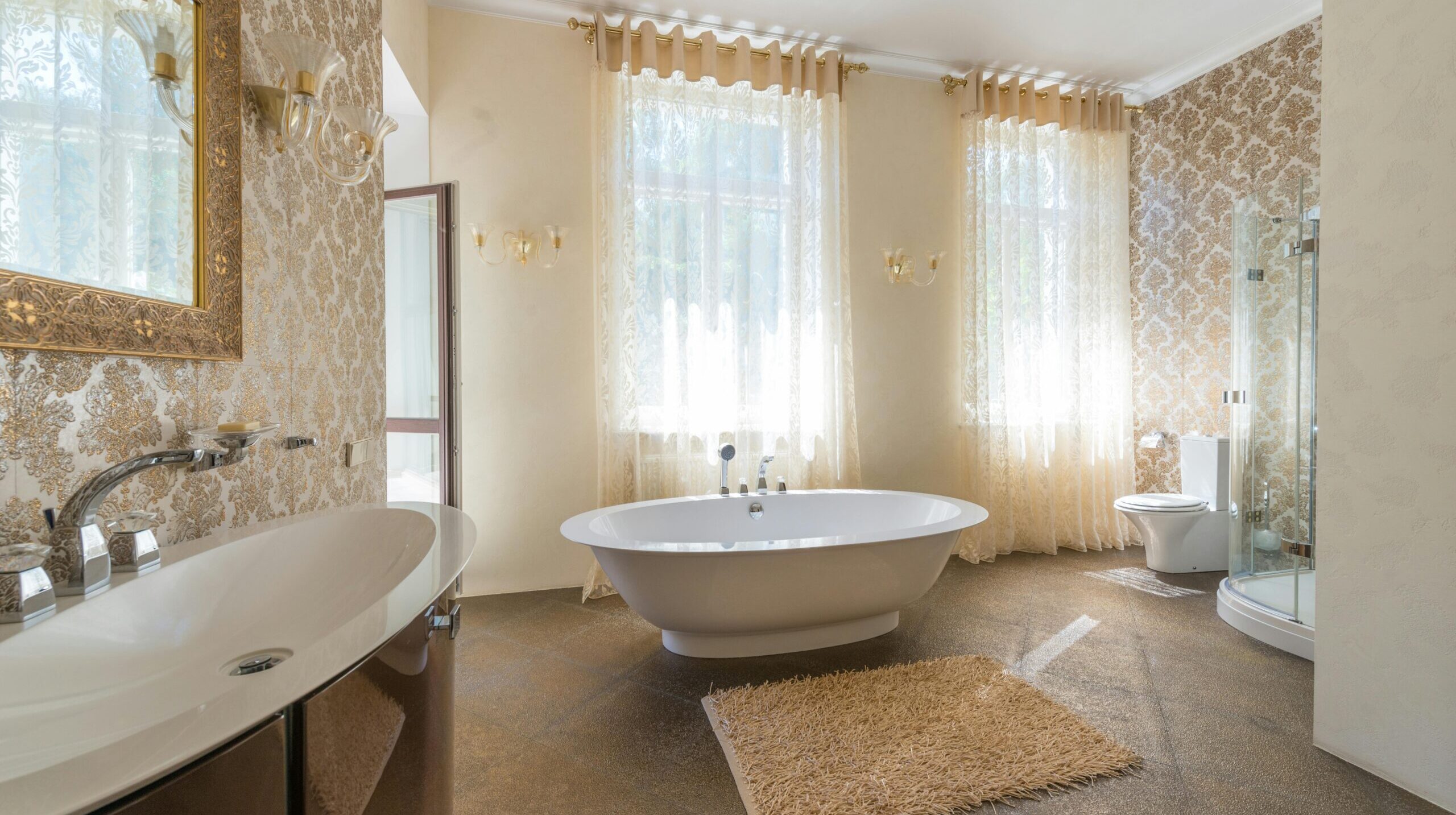 Interior of a bathroom featuring a tub, sink, and mirror.