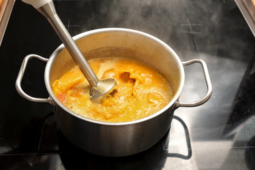 A pot of homemade soup simmering on a stovetop